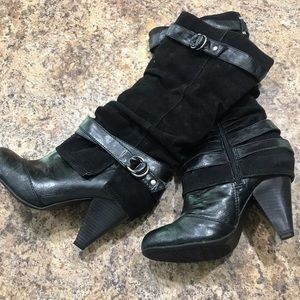 Black mid-calf length boots.